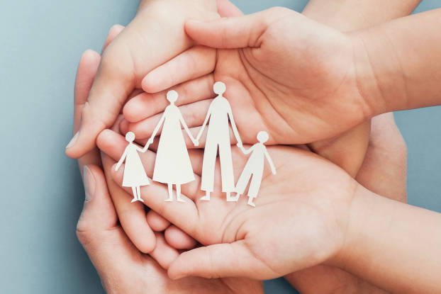 Adult and children hands holding paper family cutout, family home, foster care, homeless charity support concept, family mental health, international day of families